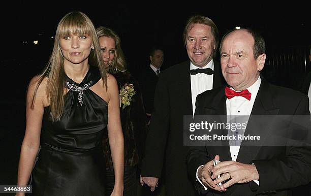 Fashion designer Collette Dinnigan and singer Glenn Shorrock arrive with Music manager Glenn Wheatley at "The Mother Of All Balls" at the Hordern...