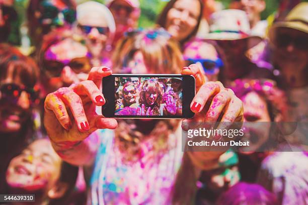 people taking a selfie together in group during a holi celebration party in the outdoor with happiness expressions and covered with vivid colors. - traditional festival bildbanksfoton och bilder