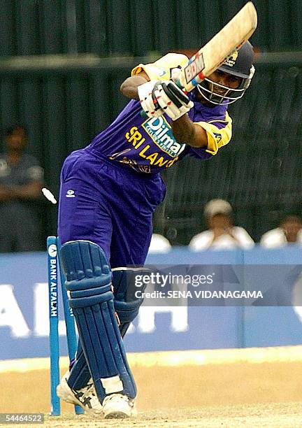 Sri Lankan cricketer Upul Tharanga is dismissed by Bangladeshi bowler Tapash Baishya during the final One Day International match between Sri Lanka...