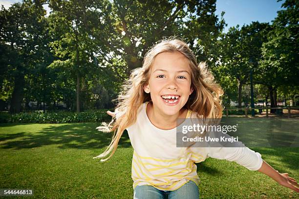 girl playing in park - brown eyes stock pictures, royalty-free photos & images