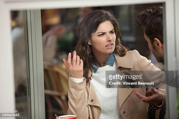 couple arguing in a cafe - fighting stock pictures, royalty-free photos & images
