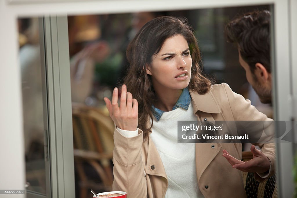 Couple arguing in a cafe