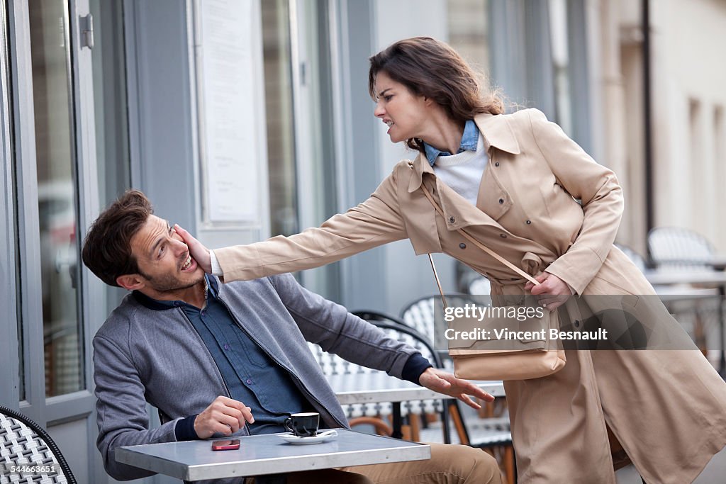 Woman slapping a man in the street