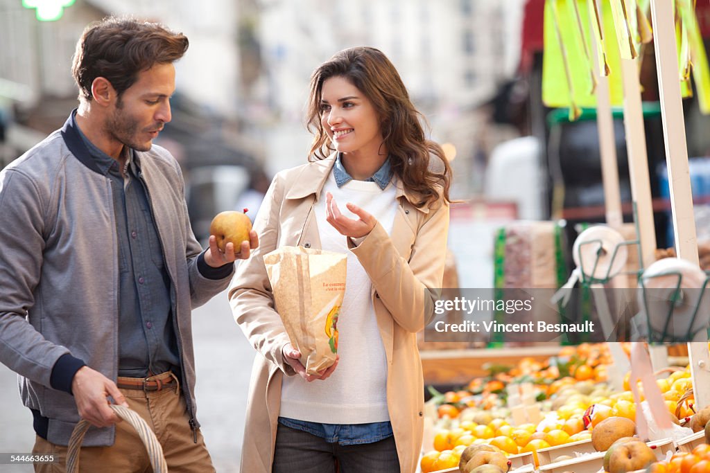 Couple buying fruit at the market