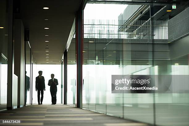 business concepts - 2 businessmen in silhouette stock pictures, royalty-free photos & images