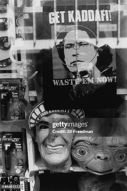 Tear gas, handcuffs, masks of Ronald Reagan and 'E.T.: The Extra-Terrestrial', and a poster of Libyan leader Muammar Gaddafi, displayed in a shop...