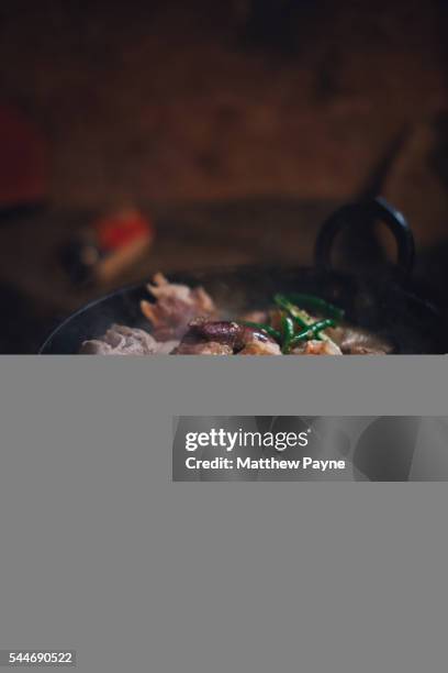 nagaland, india: traditional nagaland dish of pork, chillies and dried bamboo on open fire - nagaland stock pictures, royalty-free photos & images