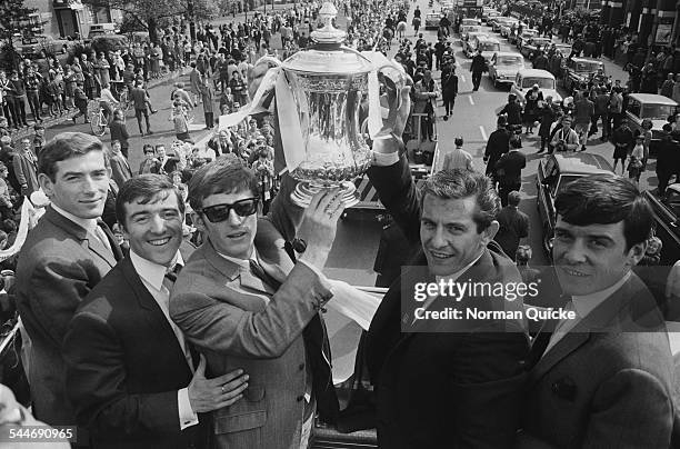 Tottenham Hotspur players L-R: Pat Jennings, Terry Venables, Jimmy Robertson, Alan Mullery, and Cyrille Knowles display the FA Cup trophy to jubilant...