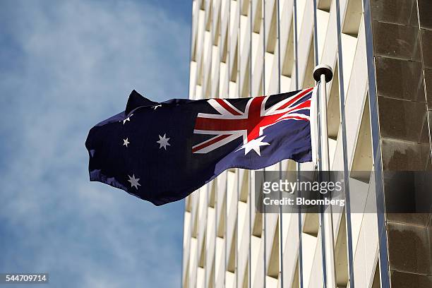 The Australian flag flies outside the Reserve Bank of Australia headquarters in Sydney, Australia, on Monday, July 4, 2016. Australia's failure to...