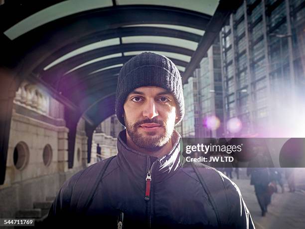 portrait of young man, in urban street - winter coat stock pictures, royalty-free photos & images