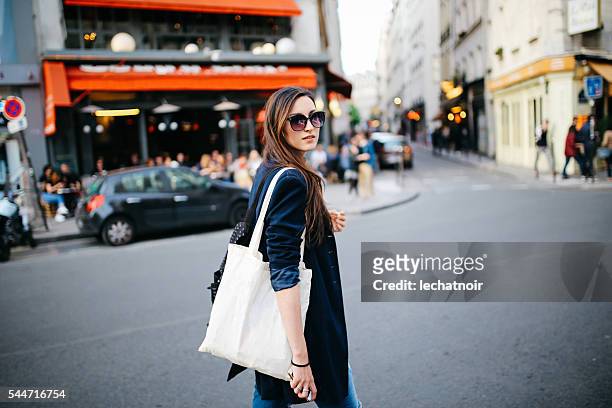 young tourist woman walking in paris - street style paris stock pictures, royalty-free photos & images