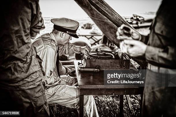 naval officer enjoying the music on his vintage phonograph - world war ii stock pictures, royalty-free photos & images