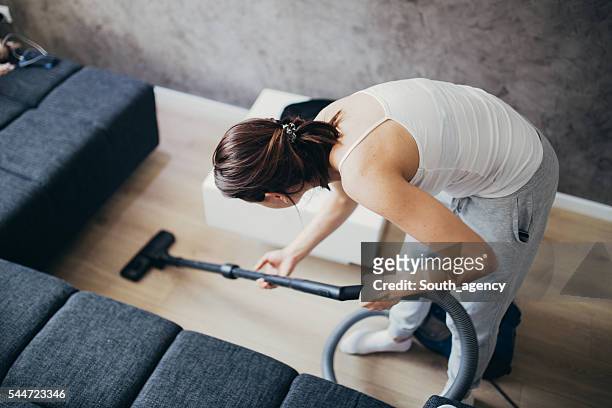 girl doing house work - wood laminate flooring stockfoto's en -beelden