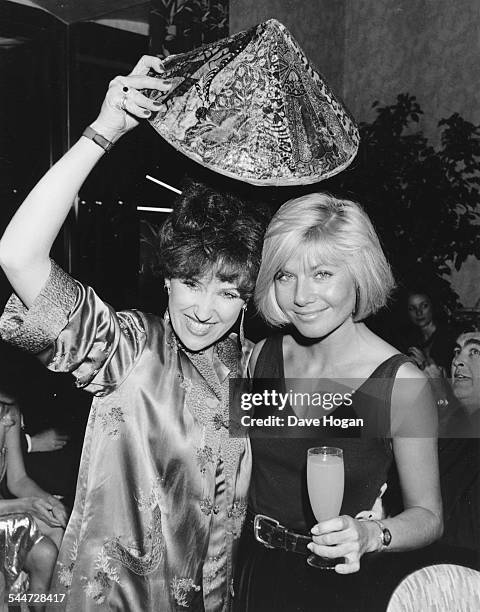 Actresses Anita Dobson and Glynis Barber joking around at the opening of a new Chinese restaurant in London, October 28th 1986.