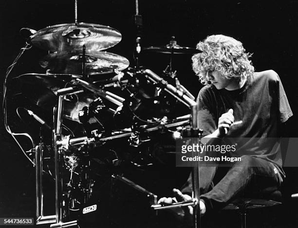Rick Allen, drummer with the band 'Def Leppard', rehearsing with his modified drum kit to accommodate the loss of his left arm, on stage in...