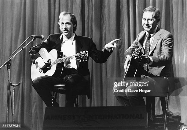 Musicians Mark Knopfler, of the band 'Dire Straits', and Chet Atkins, performing on stage at 'The Secret Policeman's Ball' at the London Palladium,...