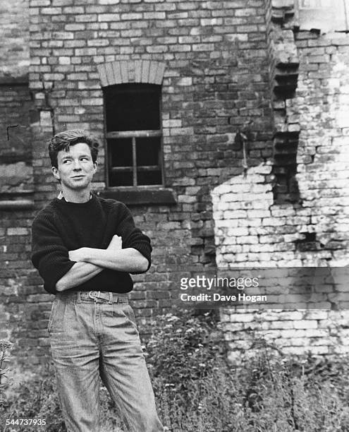 Portrait of British singer Rick Astley in front of a brick wall, circa 1985.