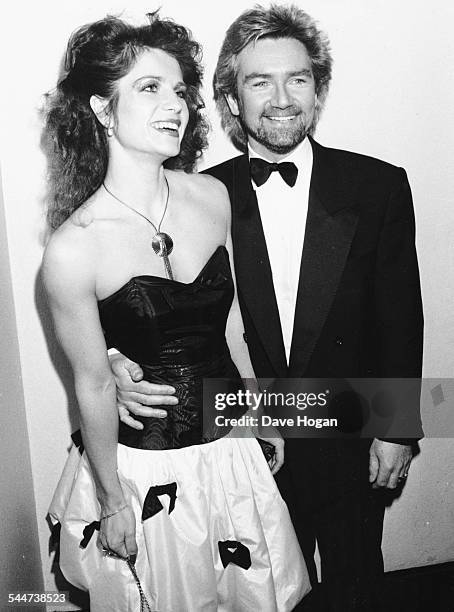 Television presenter Noel Edmonds and his wife Helen, attending the British Rock Industry Awards, London, February 1988.