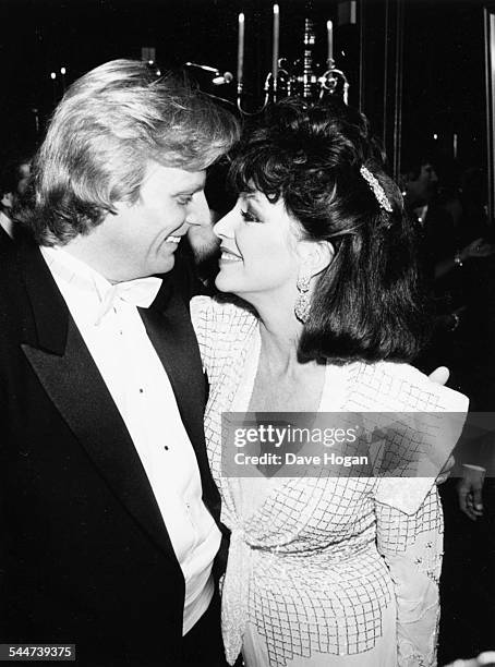 Actress Joan Collins looking into the eyes of her husband Peter Holm at Stocks nightclub in Chelsea, London, November 24th 1985.