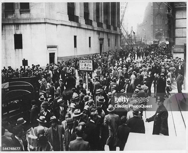 View of crowds of people on Wall Street during the stock market crash, known as Black Tuesday, New York, New York, October 29, 1929.