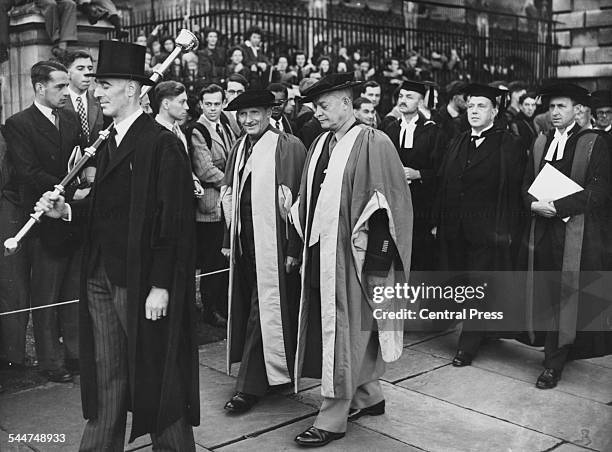 Field Marshal Viscount Montgomery and General Dwight Eisenhower wearing caps and gowns as they receive honorary degrees of Doctor of Law, at...