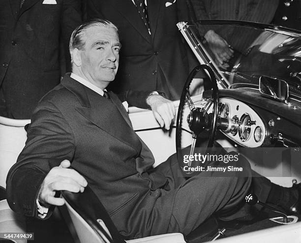 Prime Minister Sir Anthony Eden sitting at the wheel of the Austin-Healey 100 sports car, at the opening of the Motor Show at Earls Court, London,...