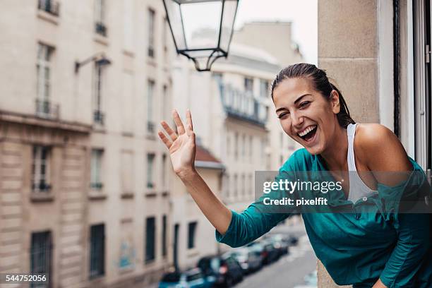 greetings from paris - female waving on street stock pictures, royalty-free photos & images