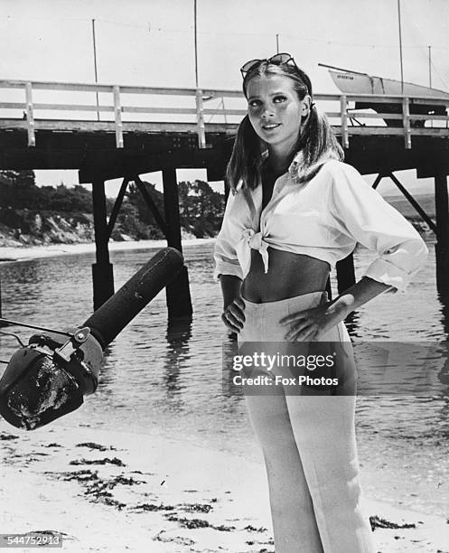 Actress Leigh Taylor-Young standing next to a pier, making the film 'The Big Bounce' on the beach at Monterey, California, December 27th 1968.