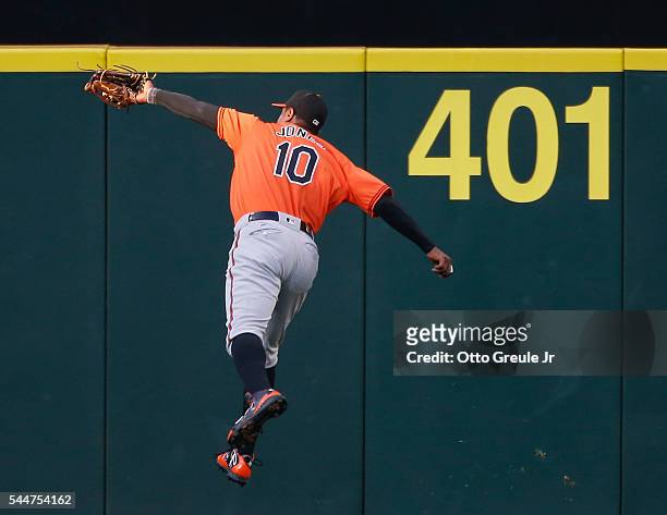 Center fielder Adam Jones of the Baltimore Orioles makes a leaping catch on a ball off the bat of Kyle Seager of the Seattle Mariners in the third...