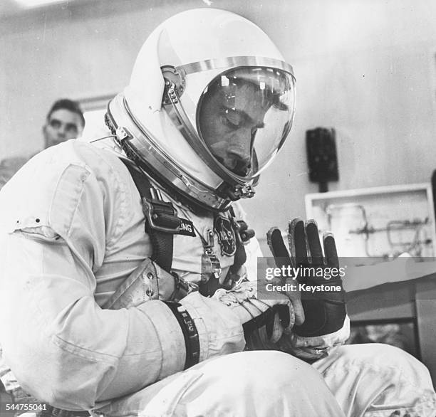 Astronaut John W Young, co-pilot of the NASA Gemini 3 mission, inspecting his spacesuit at the Complex 16 suiting-up area, March 23rd 1965.