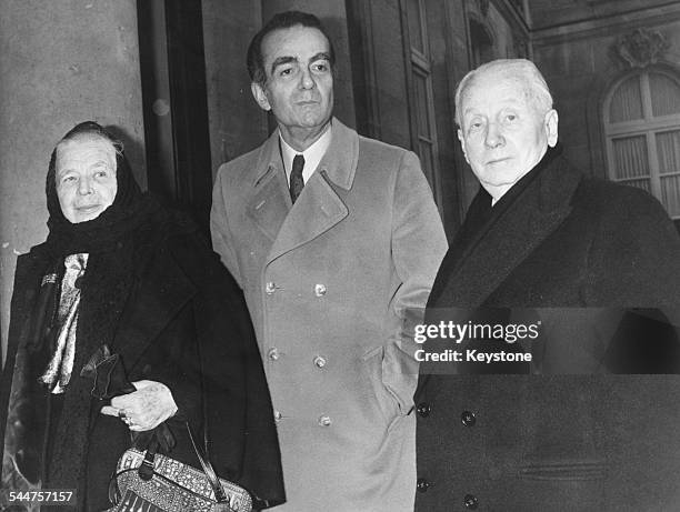 French novelist Marguerite Yourcenar with author Michel Driot and the Duke de Gastries, Director of the Academic Institute of France, on the steps of...