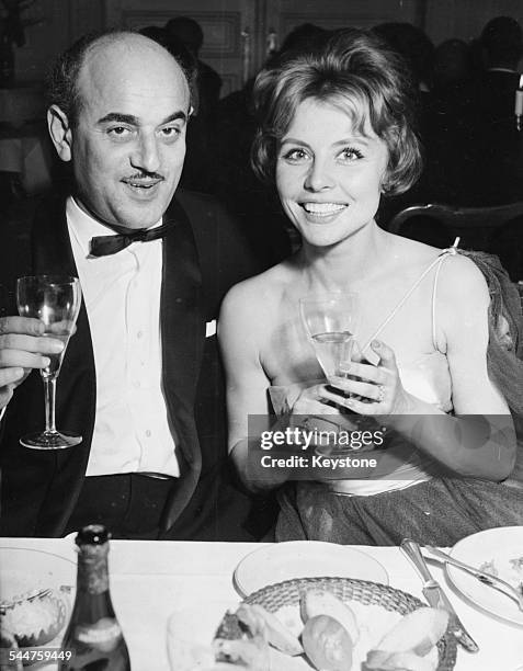 German actress Sonja Ziemann with producer Artur Brauner, sitting together at the opening of UPA Cinema in Hamburg, February 27th 1958.