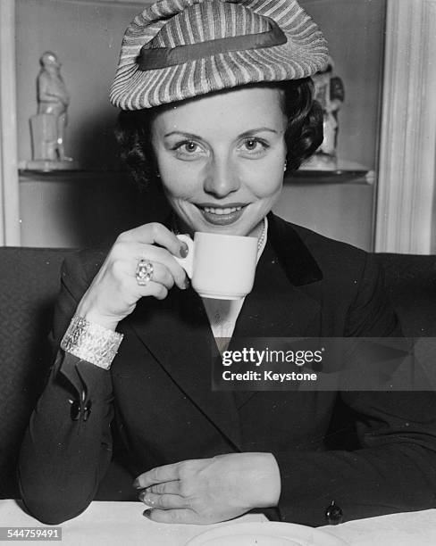 Portrait of German actress Sonja Ziemann drinking a cup of tea in the House of Commons, London, May 16th 1952.