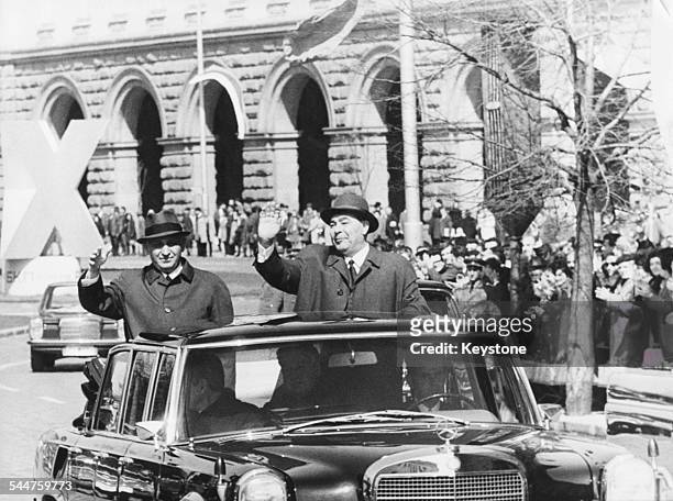 Bulgarian Prime Minister Todor Zhivkov , first Secretary of the Communist Party, and General Secretary Leonid Brezhnev, waving from the back of a car...