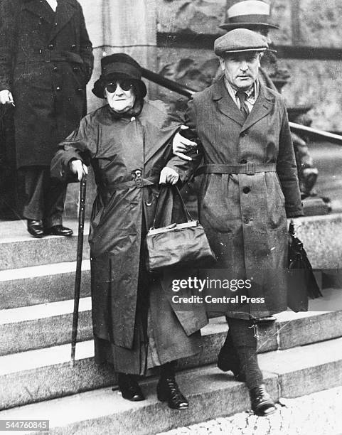 German women's rights activist Clara Zetkin being helped down the steps of a church, 1932.