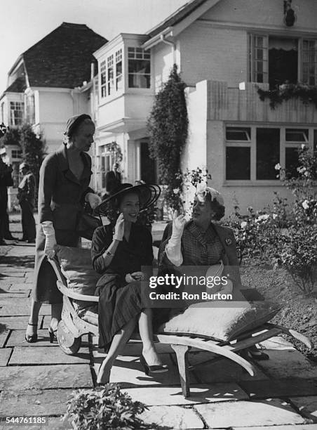 Actresses Diana Wynyard, Sally Anne Howes and Cicely Courtneidge, at the opening of a theatrical convalescence home at the home of Ivor Novello, at...