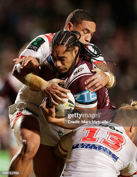 Martin Taupau of the Sea Eagles is tackled during the round 17 NRL match between the Manly Sea Eagles and the St George Illawarra Dragons at...