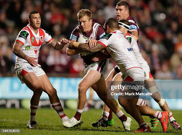 Jake Trbojevic of the Sea Eagles is tackled during the round 17 NRL match between the Manly Sea Eagles and the St George Illawarra Dragons at...