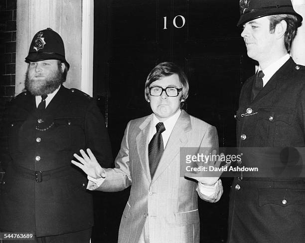 Comedian and impressionist Mike Yarwood joking around with two police officers, doing his Callaghan impersonation, outside 10 Downing Street, London,...