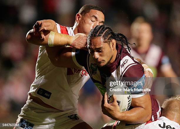 Martin Taupau of the Sea Eagles is tackled during the round 17 NRL match between the Manly Sea Eagles and the St George Illawarra Dragons at...