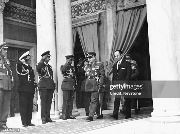 General Georgios Zoitakis, followed by G Papadopoulos, walking past a row of saluting officers, leaving Athens Cathedral, Greece, May 22nd 1969.