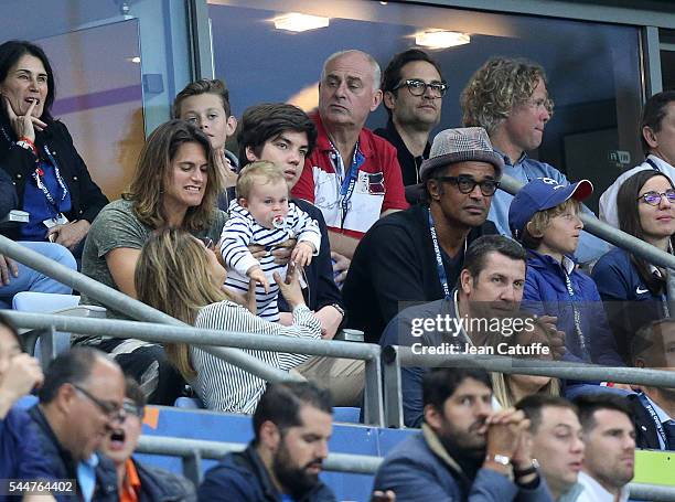 Amelie Mauresmo, Yannick Noah and his son Joalukas Noah attend the UEFA Euro 2016 quarter final match between France and Iceland at Stade de France...