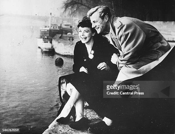 Portrait of actor Tony Wright with his new wife Janet Munro sitting by the Seine, on their honeymoon in Paris, January 15th 1957.