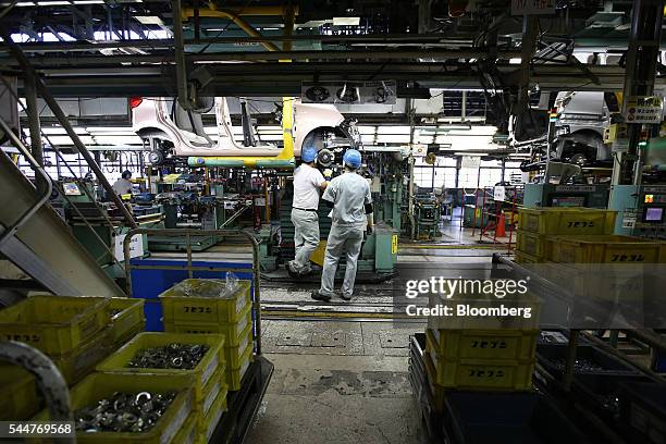 Employees assemble a vehicle on a production line at Mitsubishi Motors Corp.'s Mizushima plant in Kurashiki, Okayama Prefecture, Japan, on Monday,...