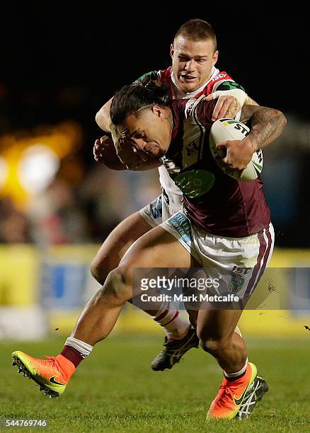 Jorge Taufua of the Sea Eagles is tackled during the round 17 NRL match between the Manly Sea Eagles and the St George Illawarra Dragons at Brookvale...