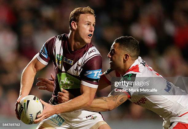 Daly Cherry-Evans of the Sea Eagles is tackled by Benji Marshall of the Dragons during the round 17 NRL match between the Manly Sea Eagles and the St...