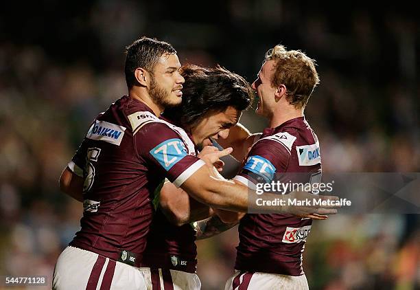 Jorge Taufua of the Sea Eagles celebrates scoring a try with team mates Daly Cherry-Evans and Brayden Wiliame during the round 17 NRL match between...