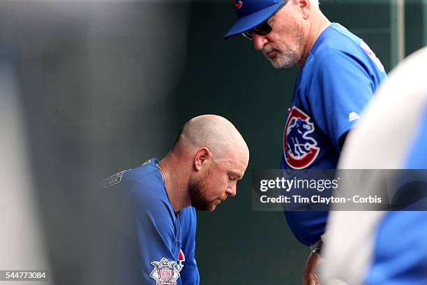 July 03: Manager Joe Maddon of the Chicago Cubs consoles pitcher Jon Lester of the Chicago Cubs after he was pulled in the second innings after...