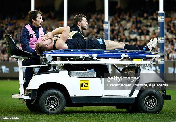 Ciaran Byrne of the Blues leaves the field on a stretcher during the 2016 AFL Round 15 match between the Carlton Blues and the Collingwood Magpies at...