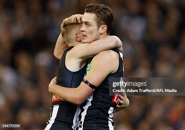 Darcy Moore of the Magpies celebrates a goal with Adam Treloar of the Magpies during the 2016 AFL Round 15 match between the Carlton Blues and the...